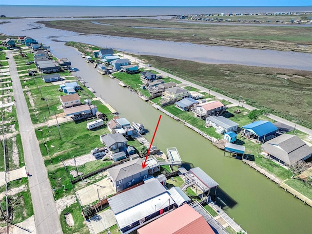 drone / aerial view with a water view and a residential view