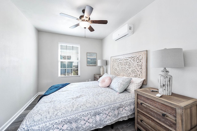 bedroom featuring dark wood finished floors, baseboards, a wall unit AC, and a ceiling fan