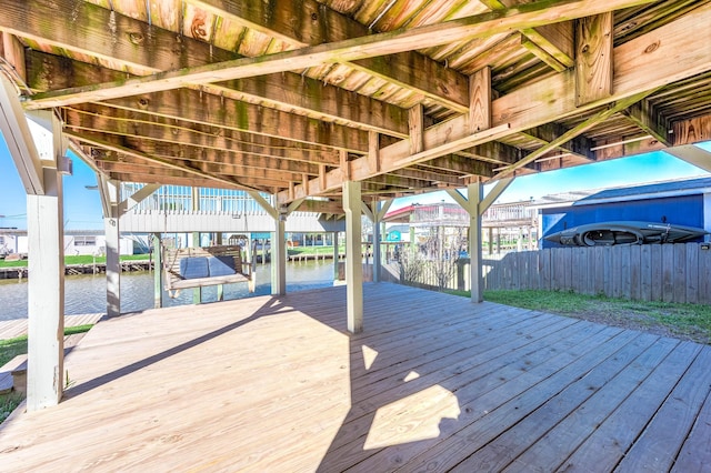 wooden deck with a water view and a dock