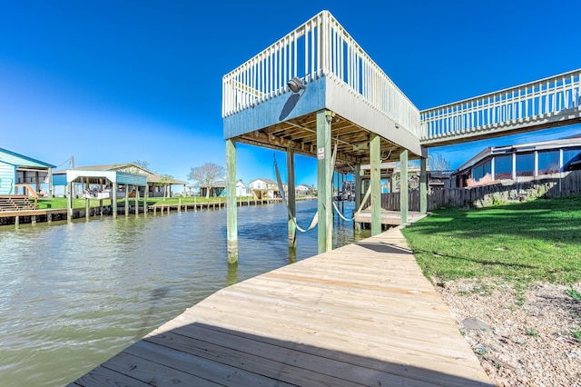 dock area featuring a water view and a yard