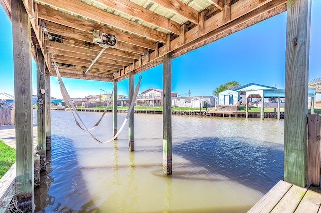 view of dock with a residential view and a water view