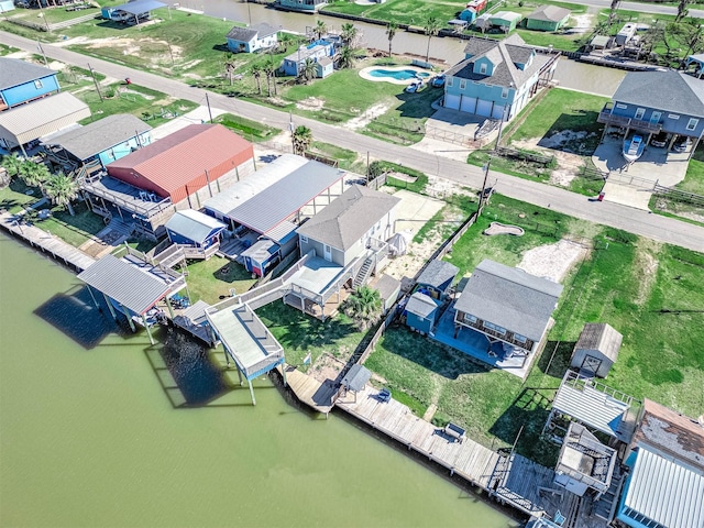 drone / aerial view featuring a residential view and a water view