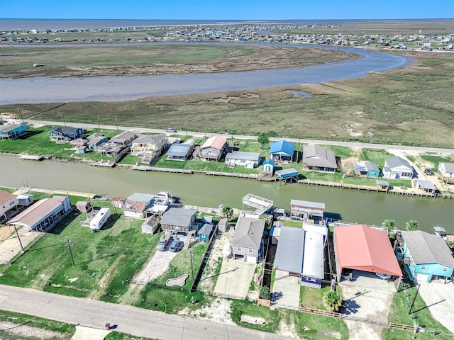 birds eye view of property with a water view and a residential view