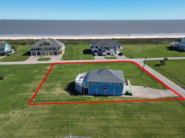 birds eye view of property with a water view and a view of the beach