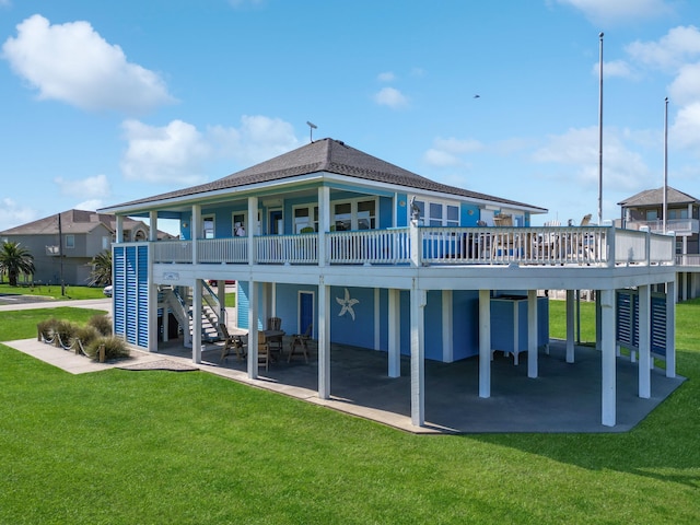back of house featuring stairs, a patio, a carport, a yard, and a shingled roof