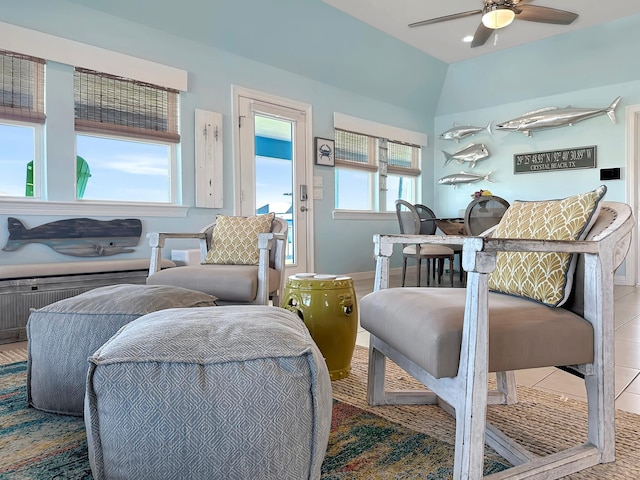 tiled living area featuring baseboards and ceiling fan