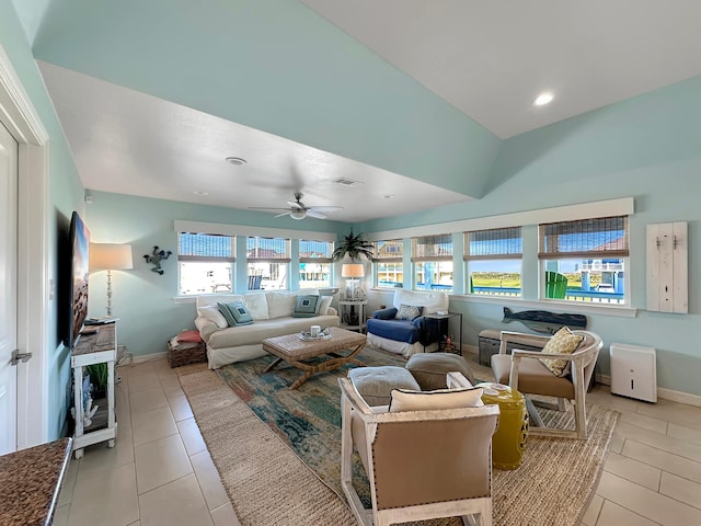 living area featuring a ceiling fan, light tile patterned flooring, baseboards, and visible vents