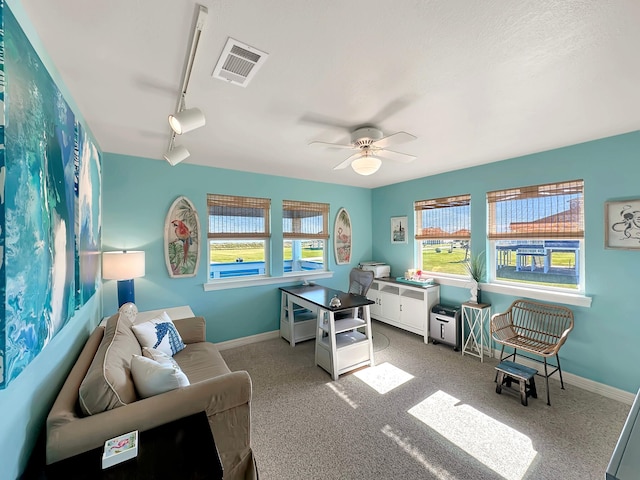 office with a wealth of natural light, visible vents, ceiling fan, and track lighting