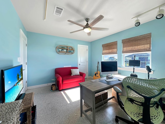 living area featuring baseboards, ceiling fan, visible vents, and track lighting