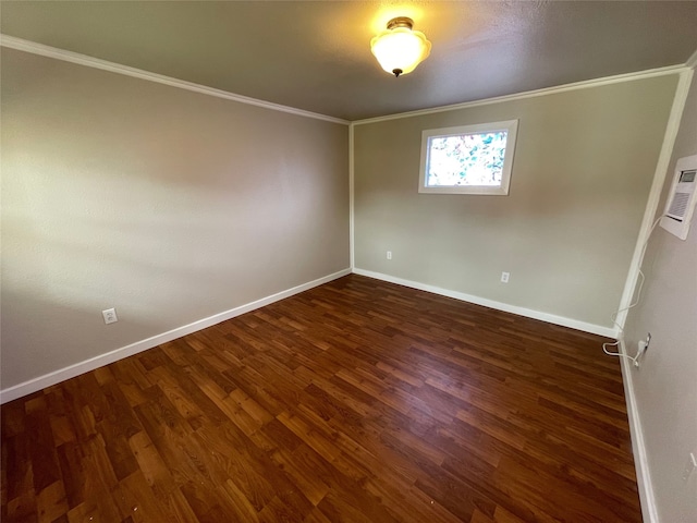 empty room featuring baseboards, ornamental molding, and wood finished floors