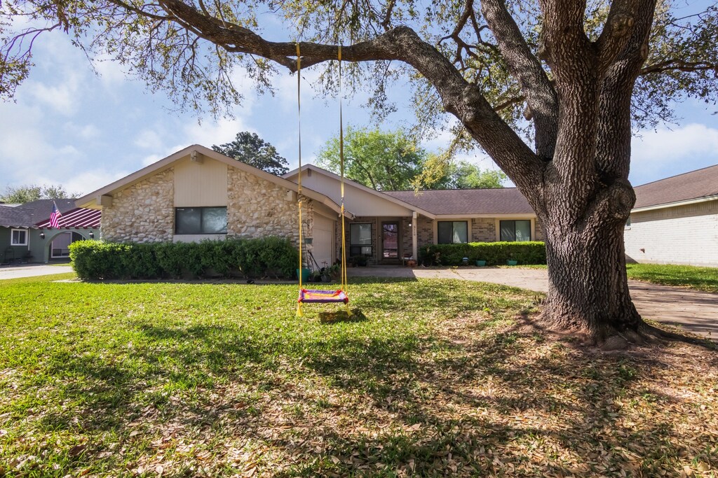 3119 Oyster Cove Dr, Missouri City, TX 77459 - view of front of property with a front yard, driveway, stone siding, and an attached garage