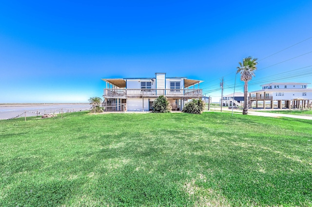 back of property featuring a lawn and a deck