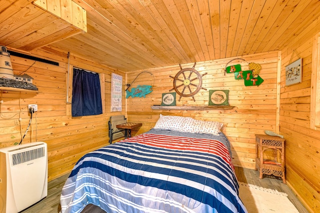 bedroom featuring wooden walls, wood finished floors, and wooden ceiling