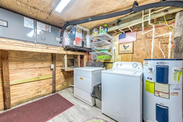 laundry area with wood finished floors, electric water heater, and washer and clothes dryer