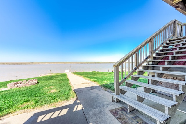 exterior space with a water view and stairway