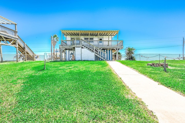 back of house with a deck, a yard, stairway, and fence