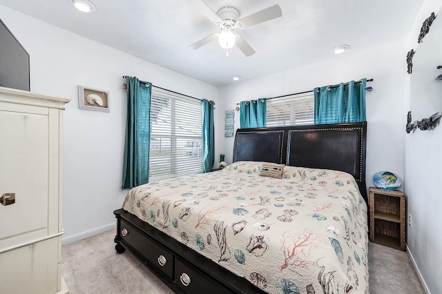 bedroom featuring baseboards, a ceiling fan, and light colored carpet