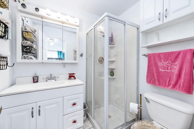 full bath with toilet, a stall shower, and vanity