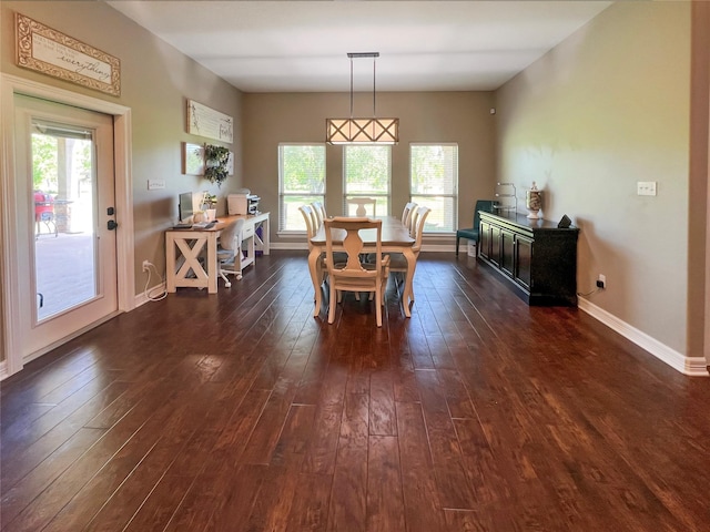 dining space with dark wood-style flooring, a wealth of natural light, and baseboards