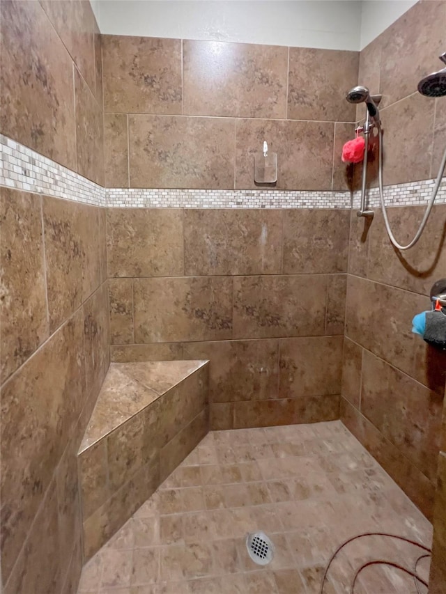 bathroom with a tile shower
