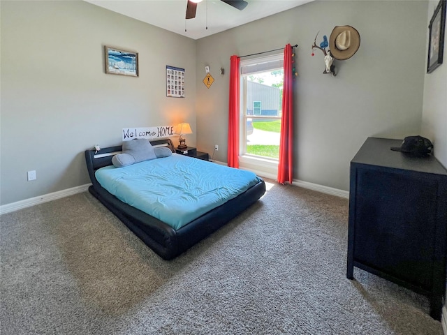 carpeted bedroom featuring baseboards and a ceiling fan