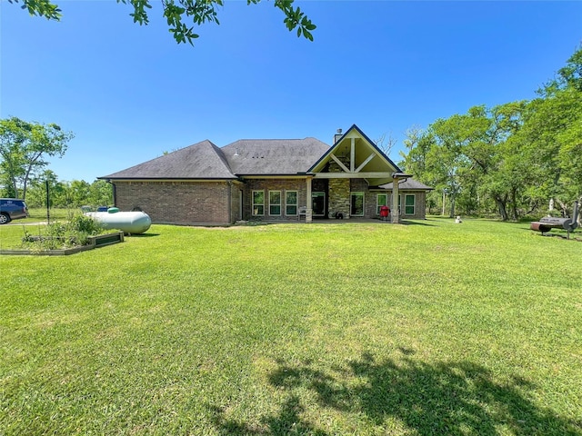 view of front of property featuring a front lawn and brick siding