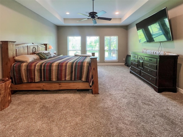 bedroom with baseboards, a raised ceiling, carpet flooring, and recessed lighting
