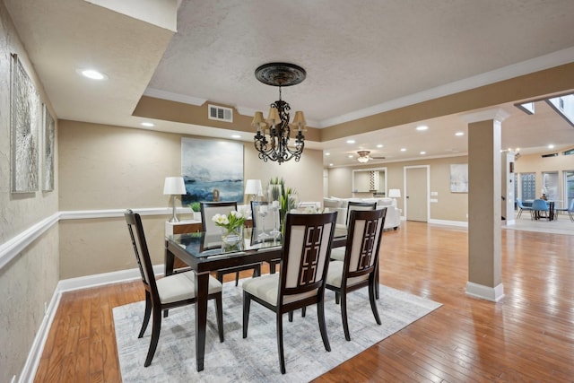 5914 Bermuda Dunes Dr, Houston, TX 77069 - dining space featuring ornamental molding, decorative columns, light wood-style flooring, a chandelier, and baseboards