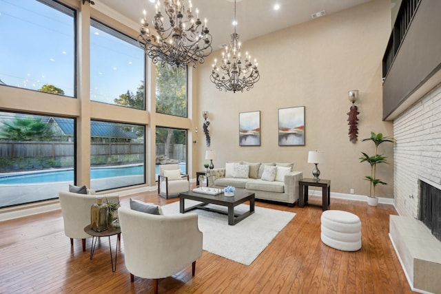5914 Bermuda Dunes Dr, Houston, TX 77069 - living area featuring a high ceiling, a fireplace, hardwood / wood-style flooring, a chandelier, and baseboards