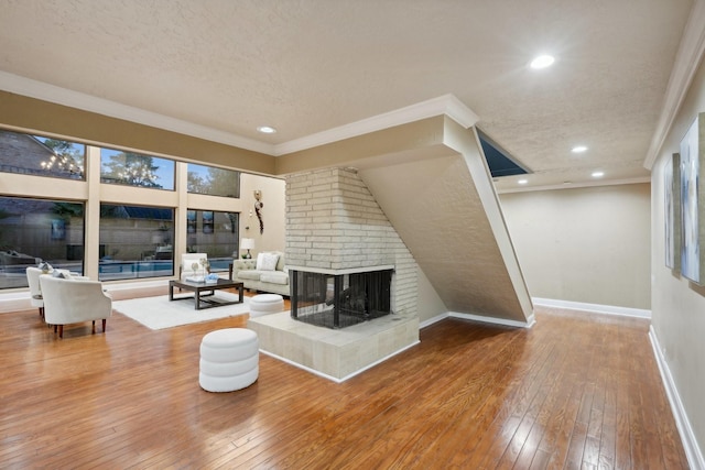 5914 Bermuda Dunes Dr, Houston, TX 77069 - living area featuring hardwood / wood-style floors, a textured ceiling, a multi sided fireplace, baseboards, and recessed lighting