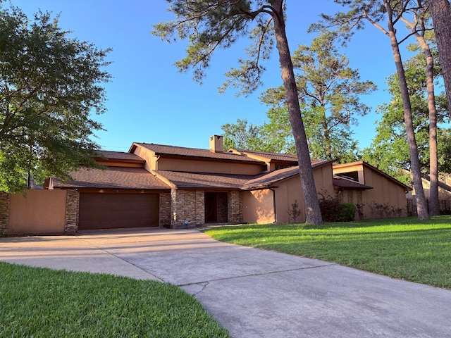 5914 Bermuda Dunes Dr, Houston, TX 77069 - view of front of house with an attached garage, a chimney, a front yard, concrete driveway, and stucco siding