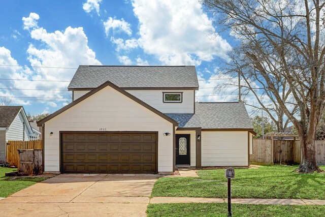 6802 Prairie Village Dr, Katy, TX 77449 - traditional-style home featuring a shingled roof, driveway, a front yard, and fence