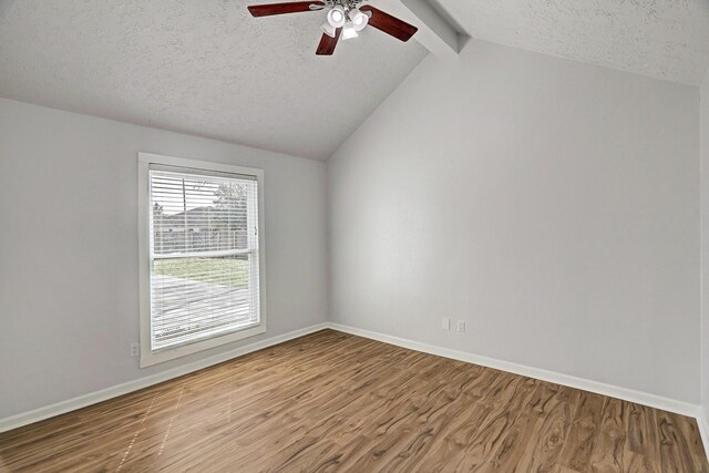 6802 Prairie Village Dr, Katy, TX 77449 - spare room with a textured ceiling, vaulted ceiling with beams, ceiling fan, and wood finished floors