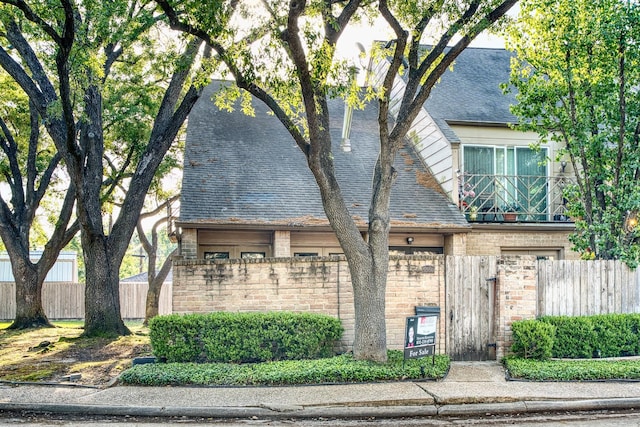 5860 Sampley Way Unit 5860, Houston, TX 77092 - view of front facade with fence private yard, roof with shingles, brick siding, and a gate