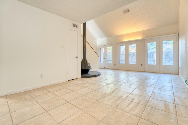 5860 Sampley Way Unit 5860, Houston, TX 77092 - spare room featuring lofted ceiling, visible vents, a textured ceiling, and light tile patterned floors