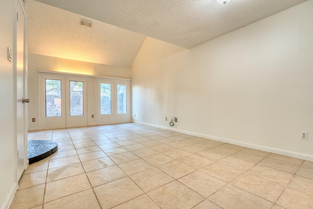 5860 Sampley Way Unit 5860, Houston, TX 77092 - empty room with a textured ceiling, light tile patterned flooring, baseboards, visible vents, and lofted ceiling