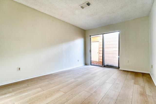 5860 Sampley Way Unit 5860, Houston, TX 77092 - unfurnished room with a textured ceiling, wood finished floors, visible vents, and baseboards