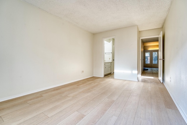 5860 Sampley Way Unit 5860, Houston, TX 77092 - empty room featuring light wood-type flooring, baseboards, and a textured ceiling