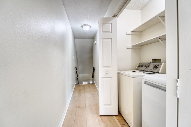 5860 Sampley Way Unit 5860, Houston, TX 77092 - clothes washing area with washing machine and clothes dryer, a textured ceiling, light wood-style floors, baseboards, and laundry area