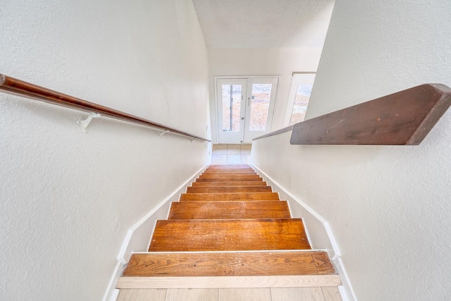 5860 Sampley Way Unit 5860, Houston, TX 77092 - stairs featuring a textured wall, french doors, and baseboards
