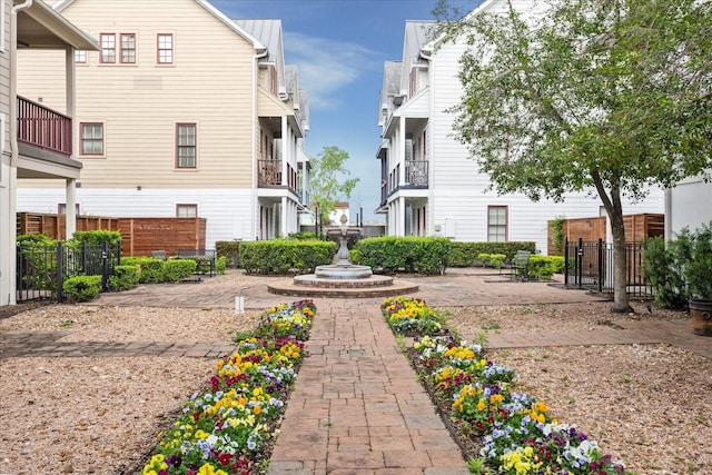 view of property's community with fence and a patio