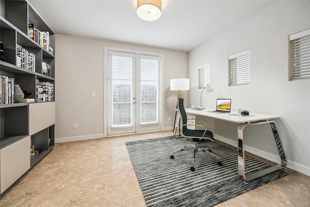 home office with baseboards, tile patterned floors, and a wealth of natural light