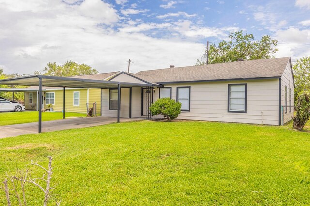 ranch-style house with concrete driveway, a shingled roof, and a front yard