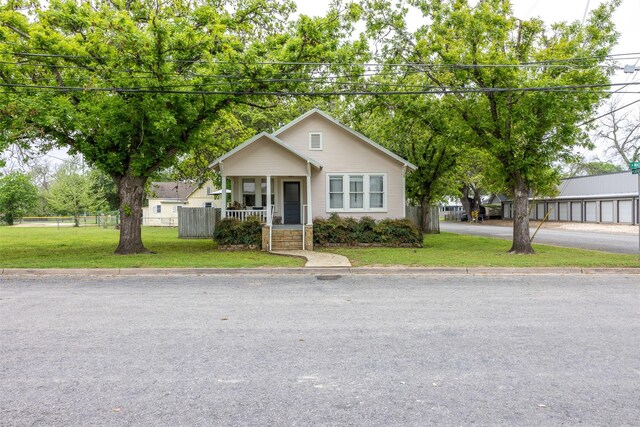 261 N Water St, La Grange, TX 78945 - bungalow-style home featuring a front yard, covered porch, and fence