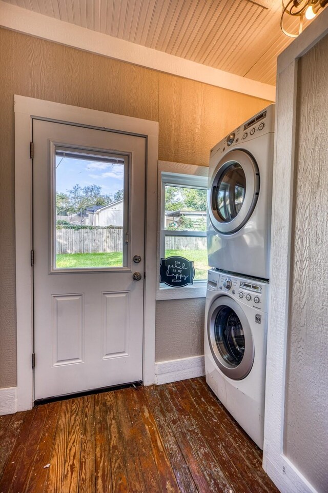607 Center St, Brenham, TX 77833 - laundry area with wood-type flooring, stacked washer / drying machine, laundry area, and baseboards