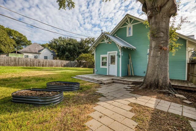 607 Center St, Brenham, TX 77833 - exterior space with a front lawn, a deck, and fence