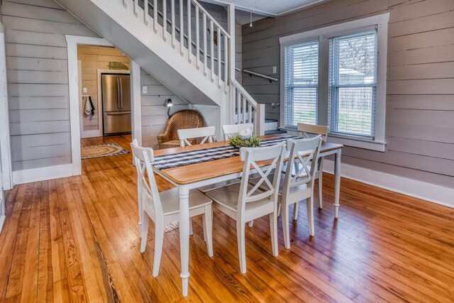 607 Center St, Brenham, TX 77833 - dining area featuring stairway, wooden walls, baseboards, and wood-type flooring