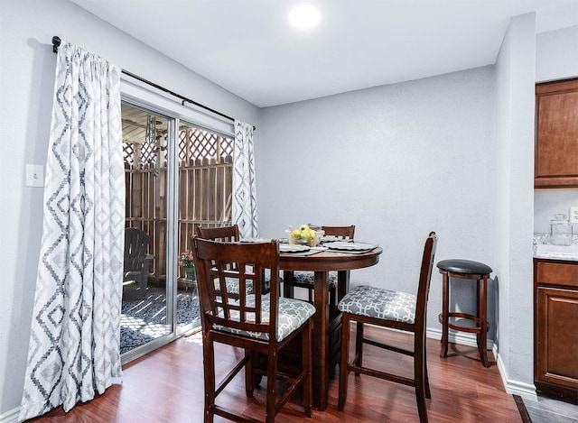 7600 Emmett F Lowry Expy Unit 807, Texas City, TX 77591 - dining area with dark wood-style flooring, baseboards, and a textured wall