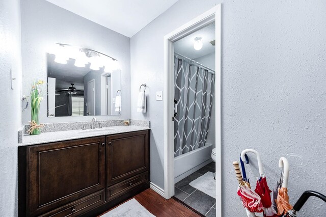 7600 Emmett F Lowry Expy Unit 807, Texas City, TX 77591 - bathroom featuring vanity, toilet, shower / tub combo with curtain, baseboards, and wood finished floors