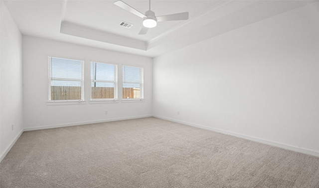 924 Wormwood Dr, League City, TX 77573 - spare room featuring a tray ceiling, light colored carpet, and a ceiling fan